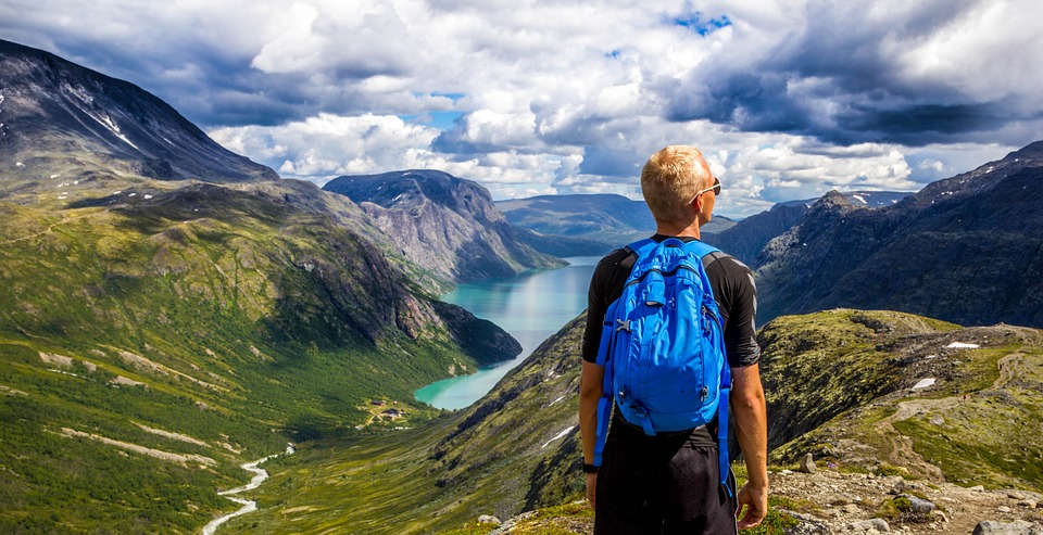 man with blue back pack